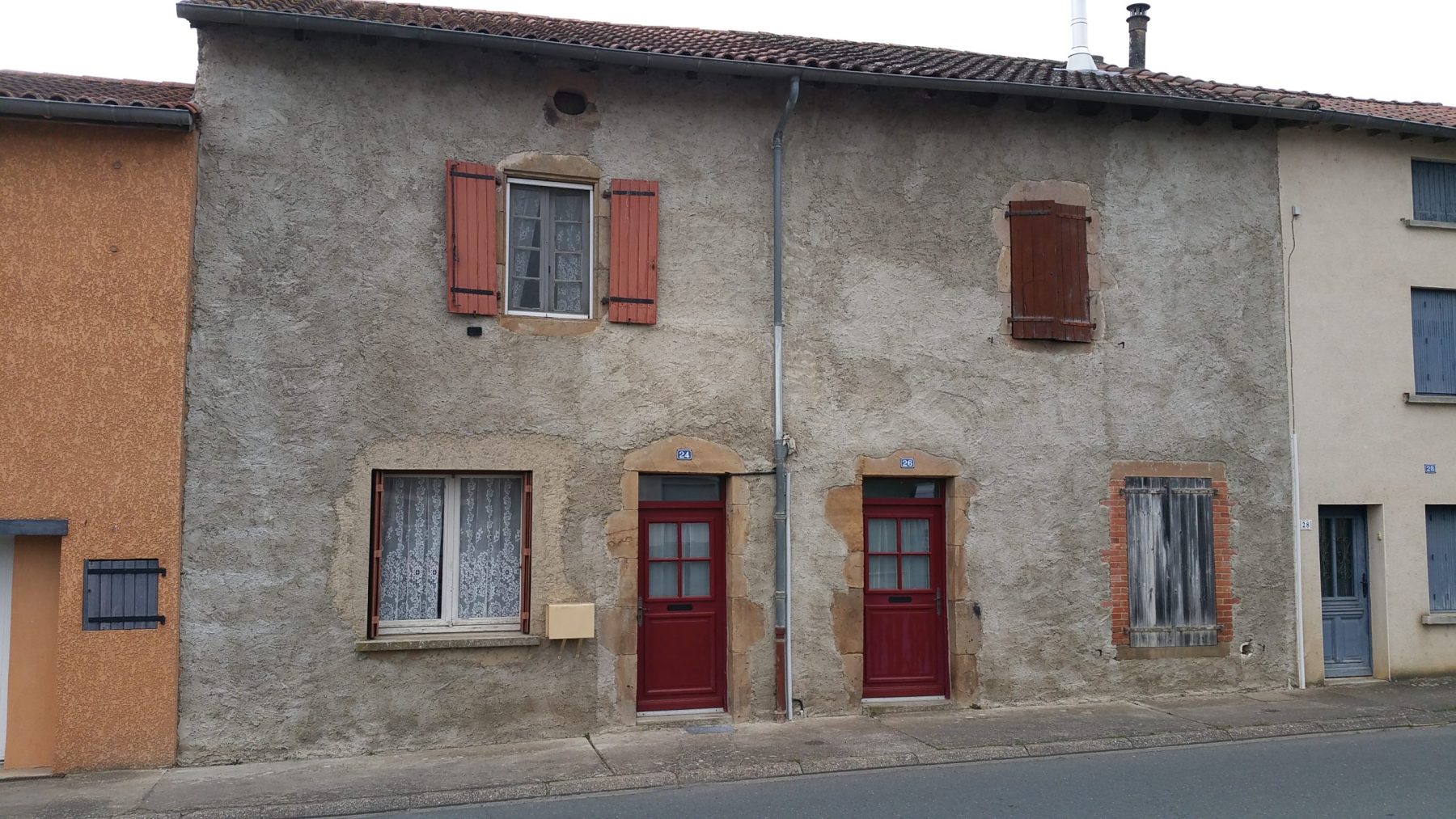 Façade de maison ancienne à rénover, enduit usé, Raval d'Oise