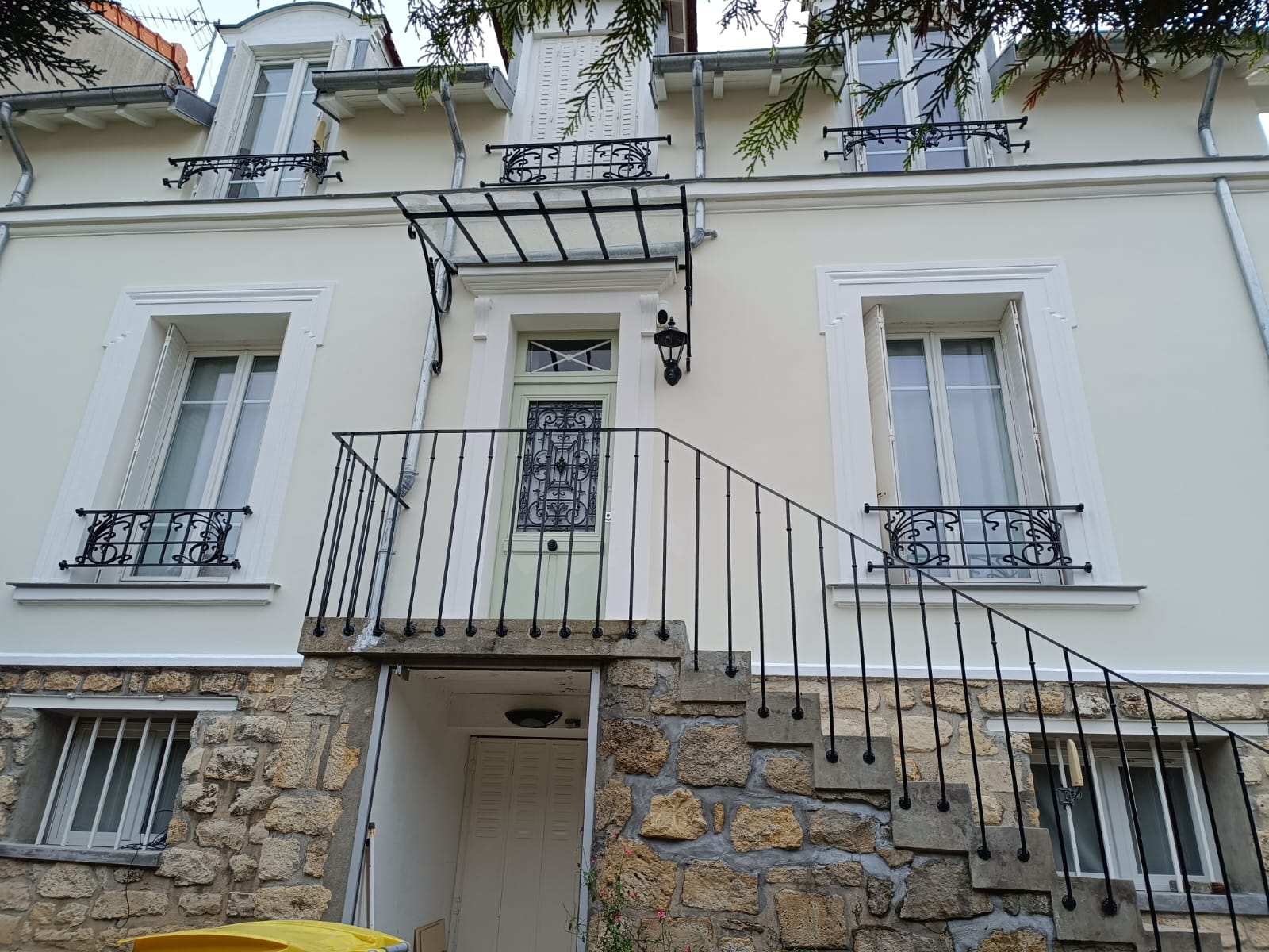 Façade de maison rénovée avec escalier extérieur par Raval d'Oise